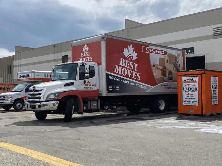 Two-person moving team from a Vancouver moving company loading household items carefully